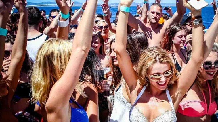 Young people celebrating on a boat int he summer