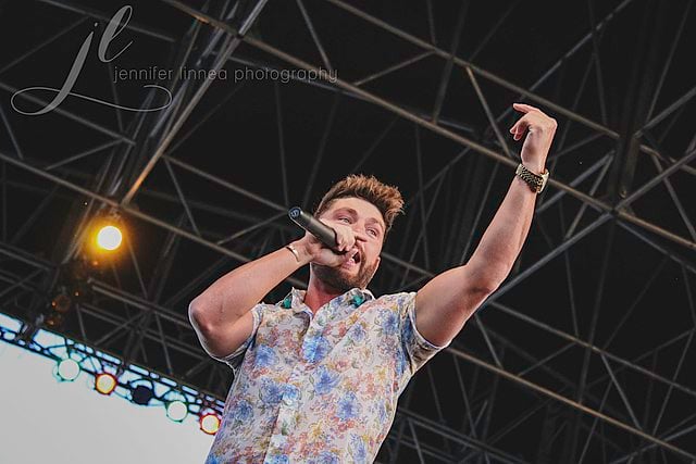 Singer Chris lane singing on stage