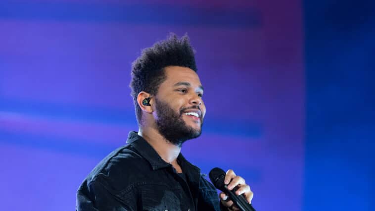 Artist, The Weekend Singing into microphone on stage