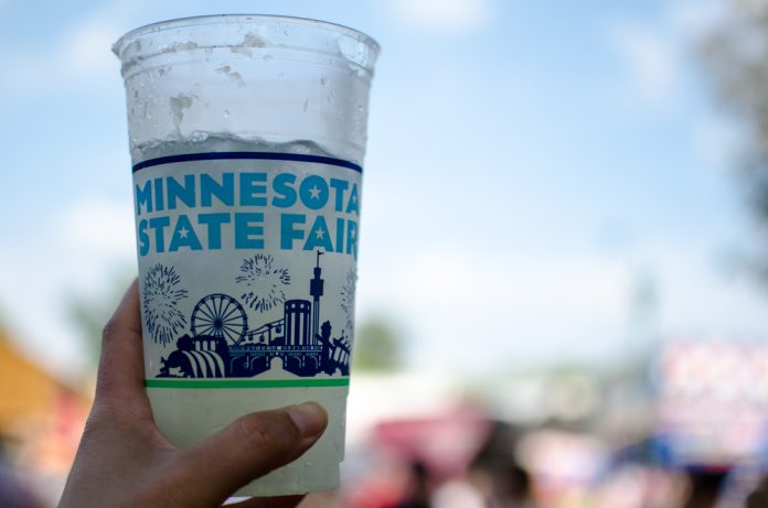 a hand holding a minnesota state fair cup