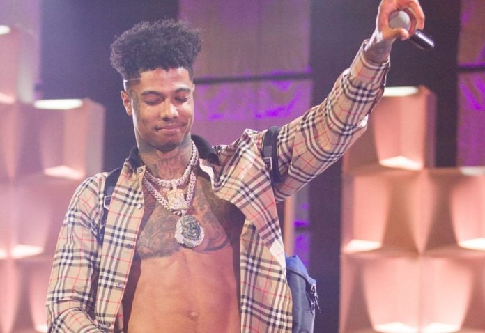 blueface's net worth image of blueface on stage holding a microphone