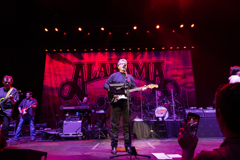 the best alabama songs the band alabama performing on stage
