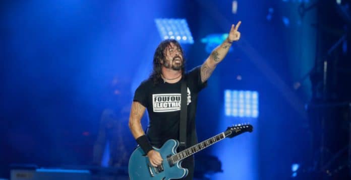 dave grohl's net worth dave grohl on stage with his guitar