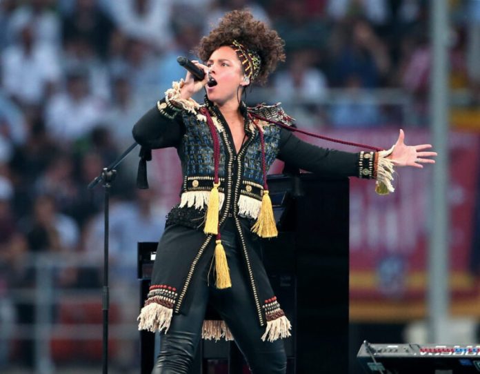 alicia keys performing on stage in a unique outfit