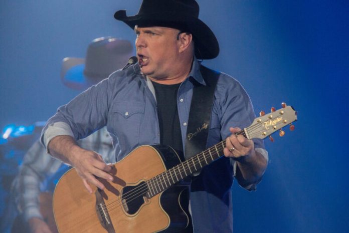 garth brook's net worth garth brooks on stage playing the guitar