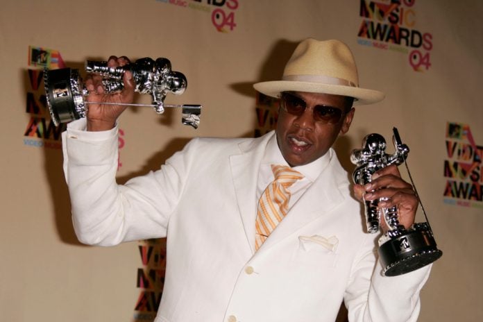 richest singers jay z holding an award in each hand