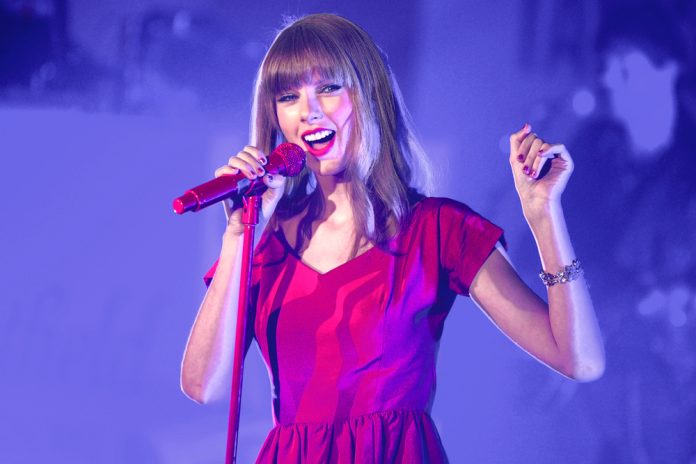 Taylor swift quotes. taylor swift on stage in 2012 in a red dress holding a microphone