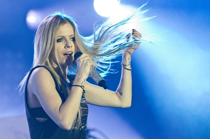 avril lavigne's net worth. avril lavigne on stage flipping her hair