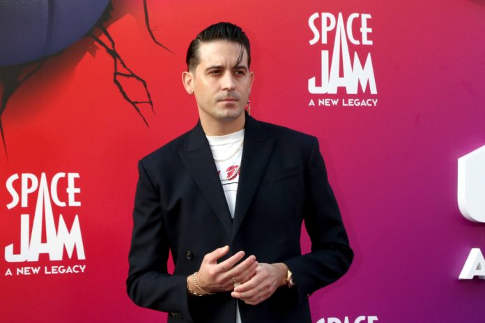 g eazy on the red carpet wearing a black suit jacket