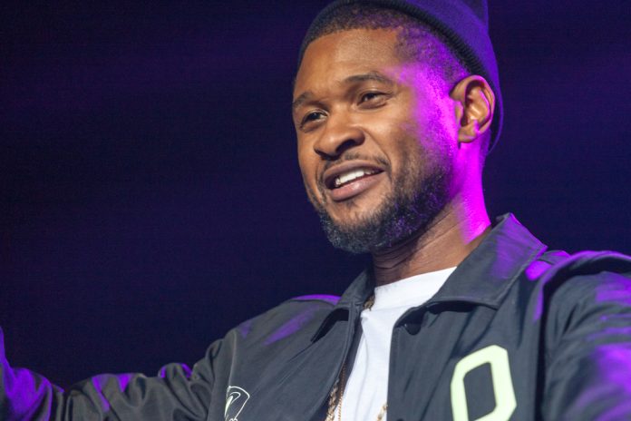 usher on stage in a collared shirt