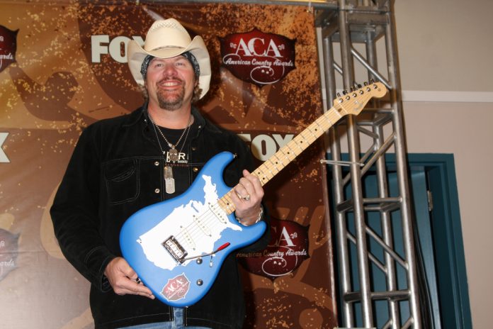 toby keith's net worth image of toby keith holding a guitar