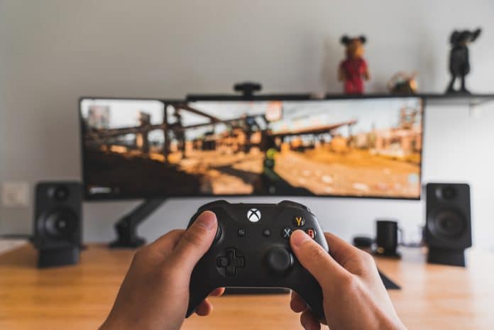 best video game songs image of a xbox controller and extra large screen set up