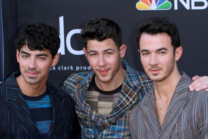 the jonas brothers in casual clothes on the red carpet