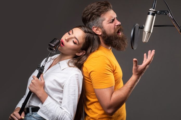 best duet songs. a couple leaning on one another singing a duet