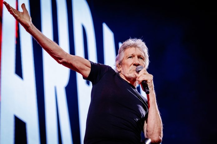 oldest singers still alive in 2023 roger waters on stage holding a microphone wearing a black shirt