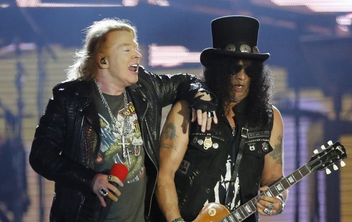 most hated famous bands of all time axl rose and slash from the band guns n roses on stage performing