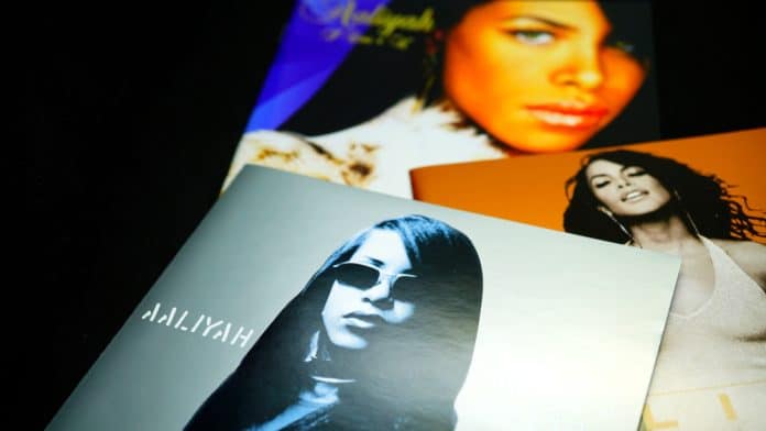 several aaliyah records stacked on each other