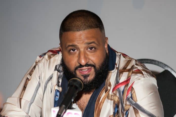 DJ khaled in a colorful shirt speaking into a microphone