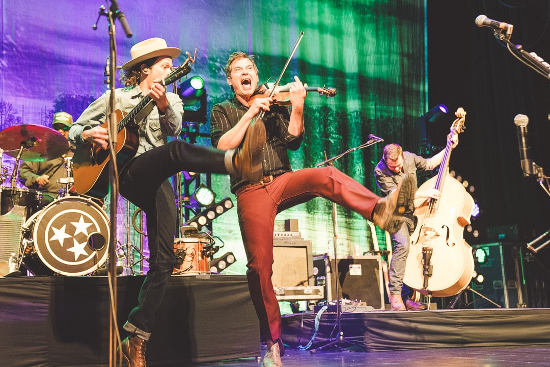 Violinist and guitarist dance while playing.