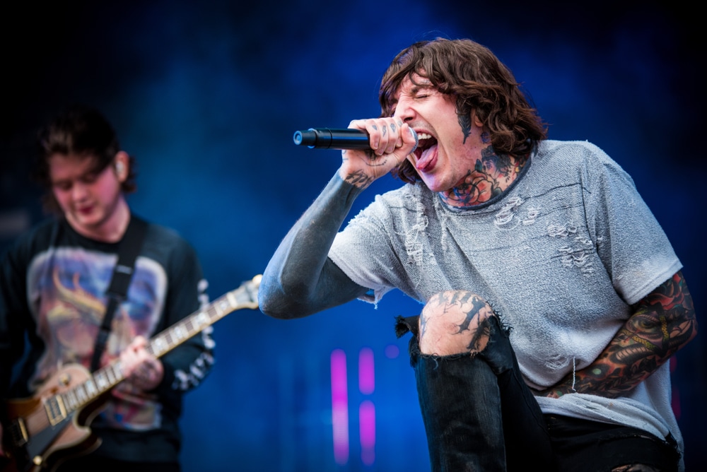 olis sykes in bring me the horizon performing on stage