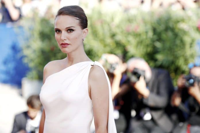 most famous female celebrities natalie portman in a white dress arriving at an event.