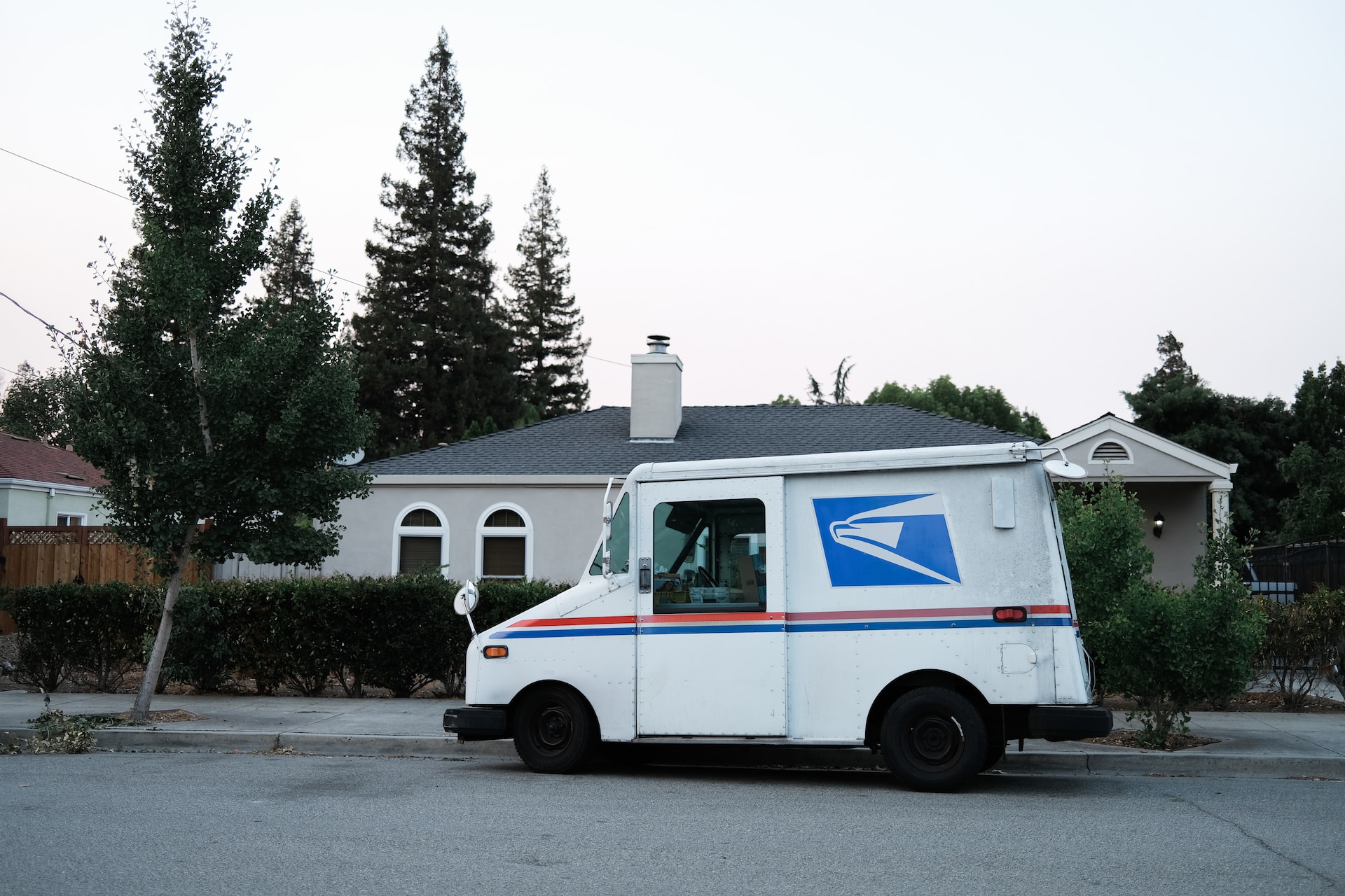 a USPS truck in front of a house