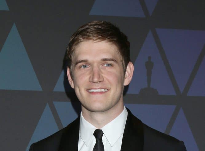 celebrities who are taller than you expected bo burnham arriving at an event wearing a suit