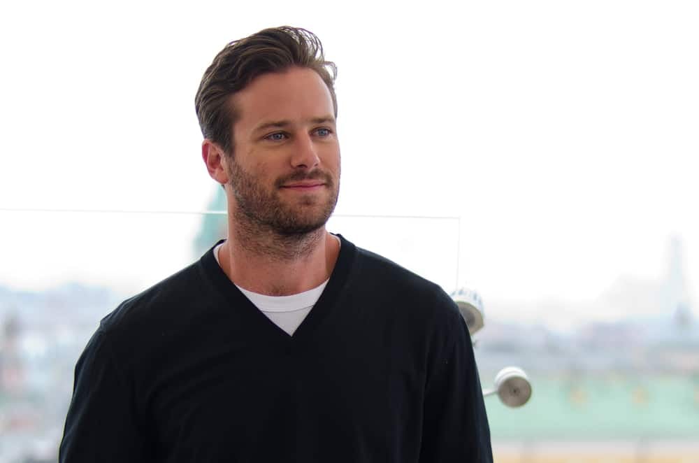 celebrities who are taller than you expected armie hammer at an event in a blue sweater in russia