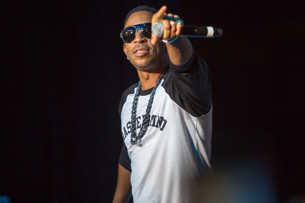 destroy lonely rapper ludacris on stage holding a microphone and pointing to the audience