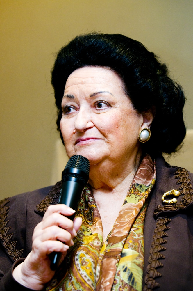 up close image of montserrat caballé holding a microphone
