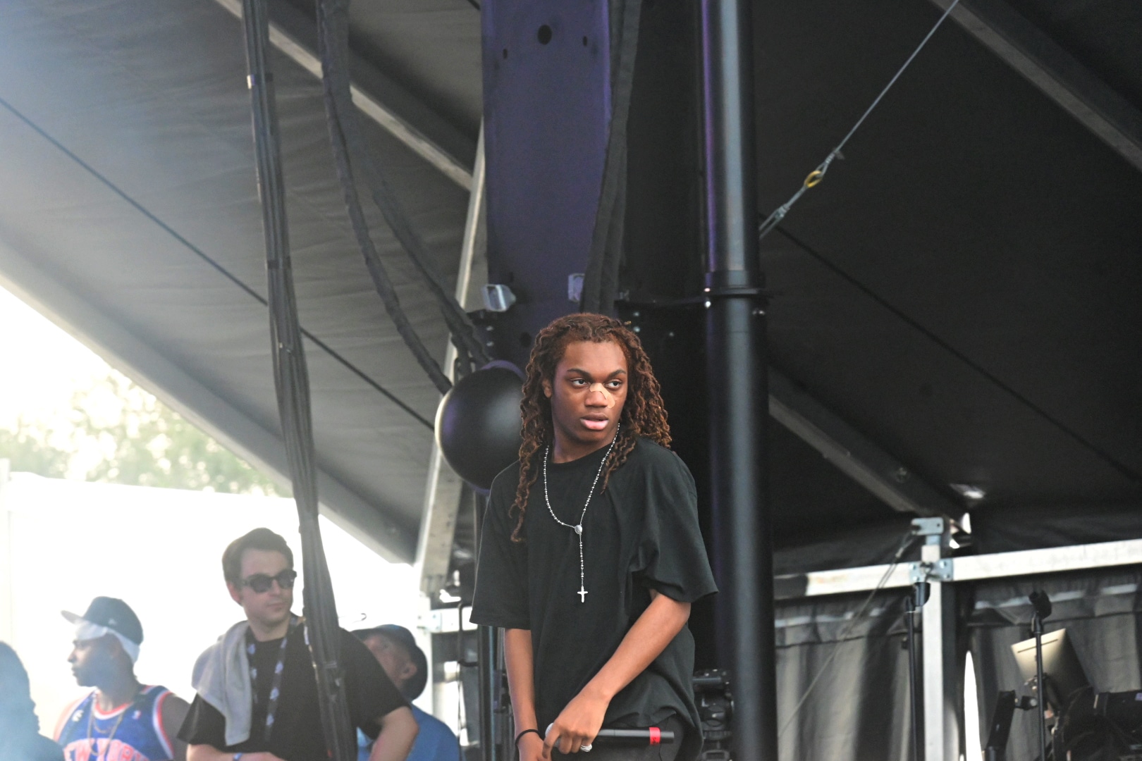 the rapper tana on stage performing in a black shirts