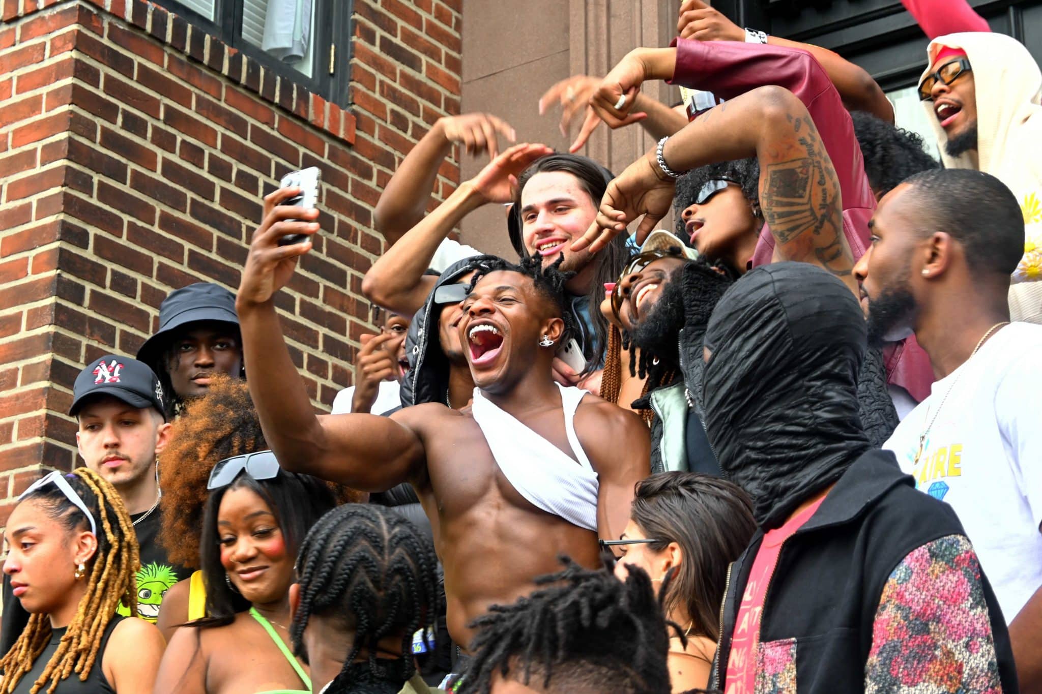 the rapper JELEEL! taking photos with a crowd of fans. JELEEL!'s net worth