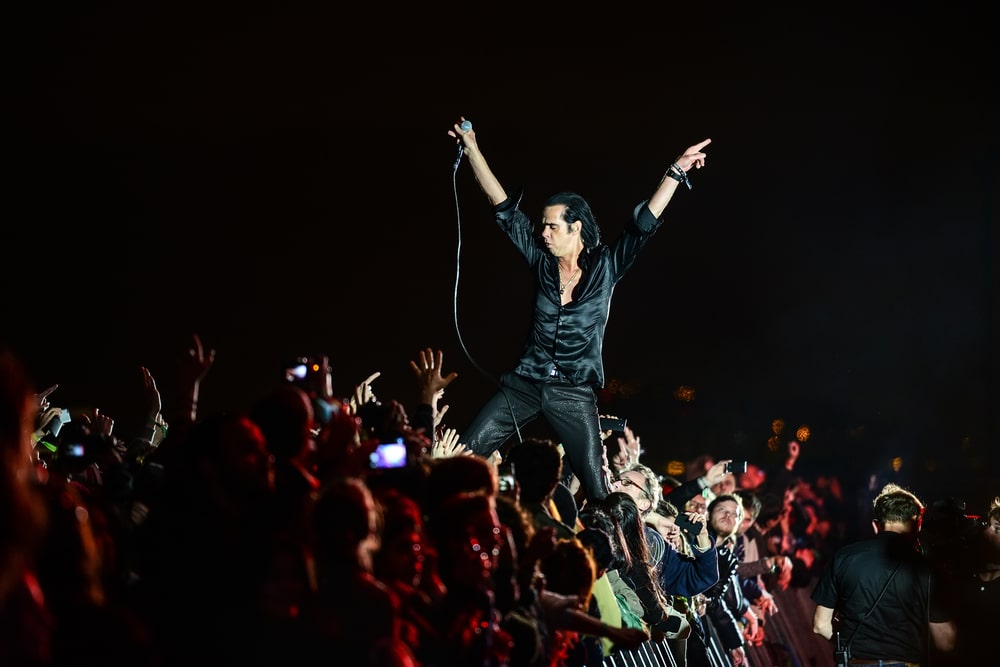nick cave nick cave performing in front of a crowd