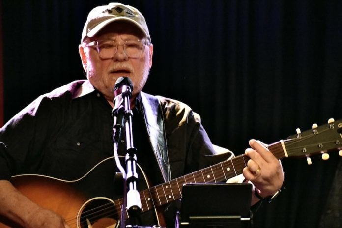 Don Sechelski playing acoustic guitar